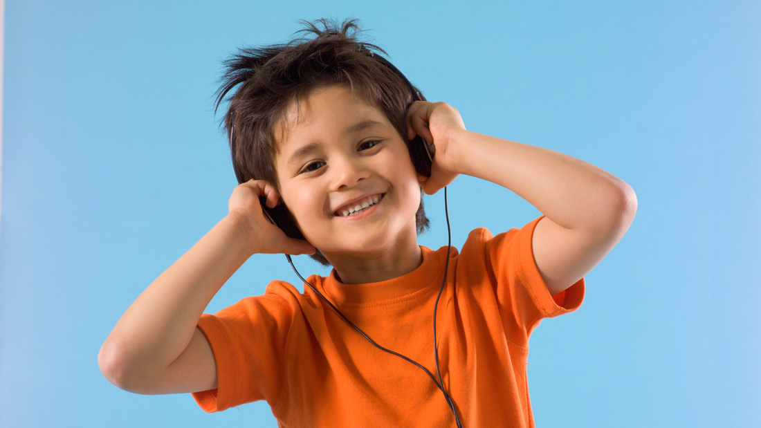 Happy boy listening to BRUSHY podcast for kids while brushing their teeth